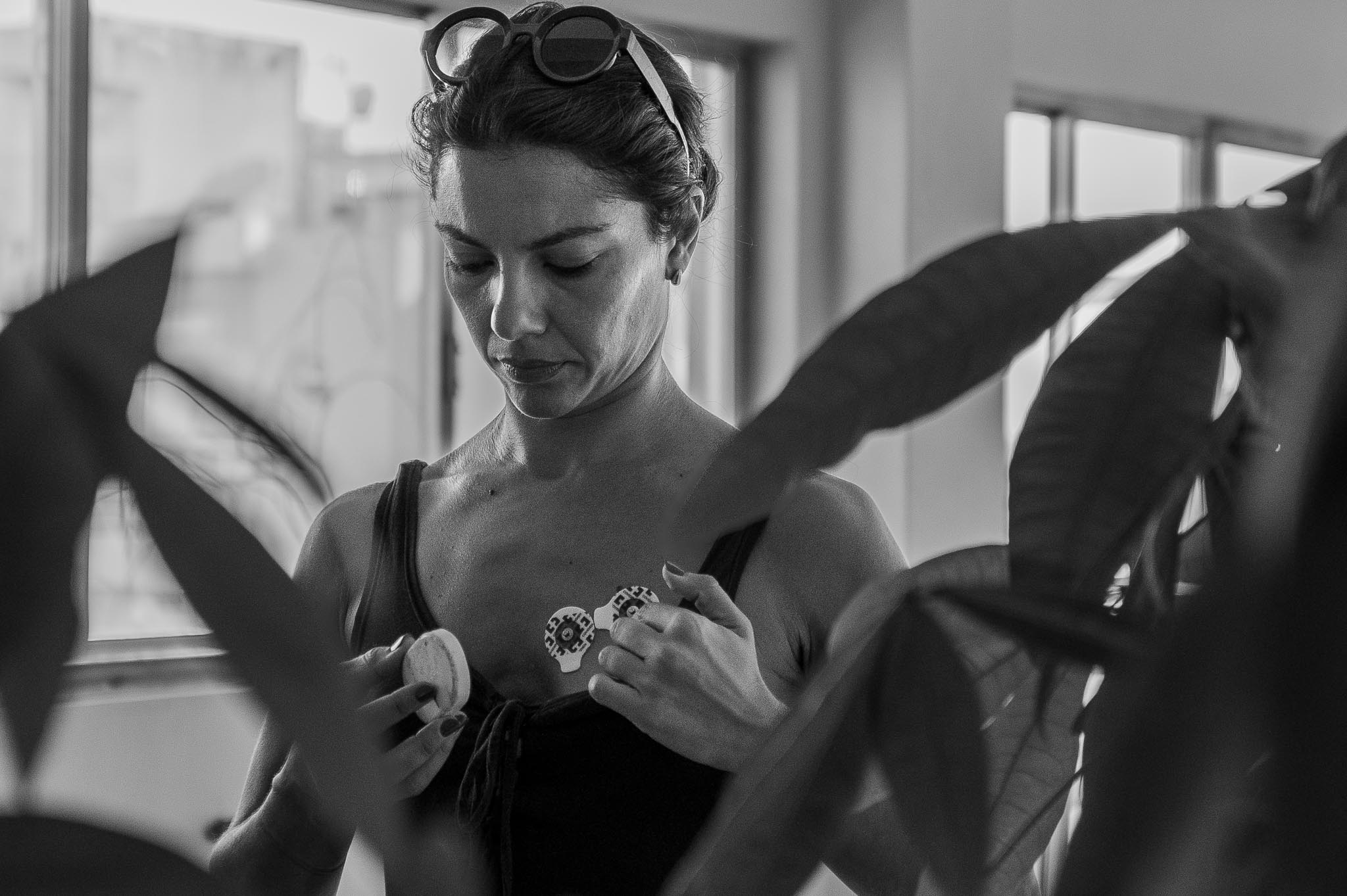 Vilelmini placing sensors on her chest during the workshop, preparing for a movement-based exercise.